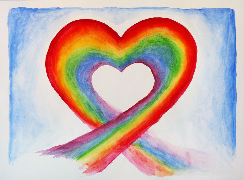 Rainbow colored heart against a blue sky